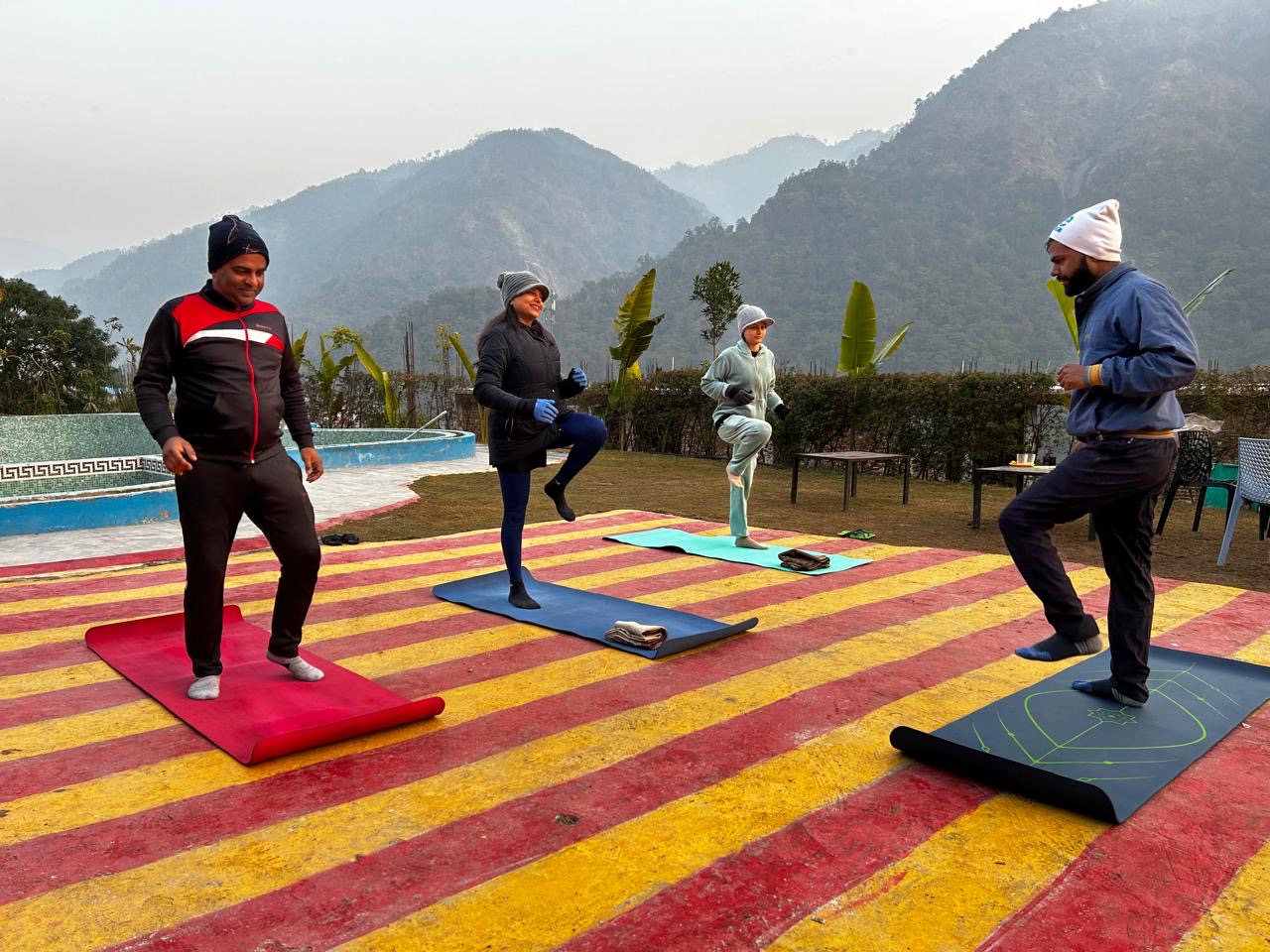 Group yoga session at a Himalayan retreat with mountain views